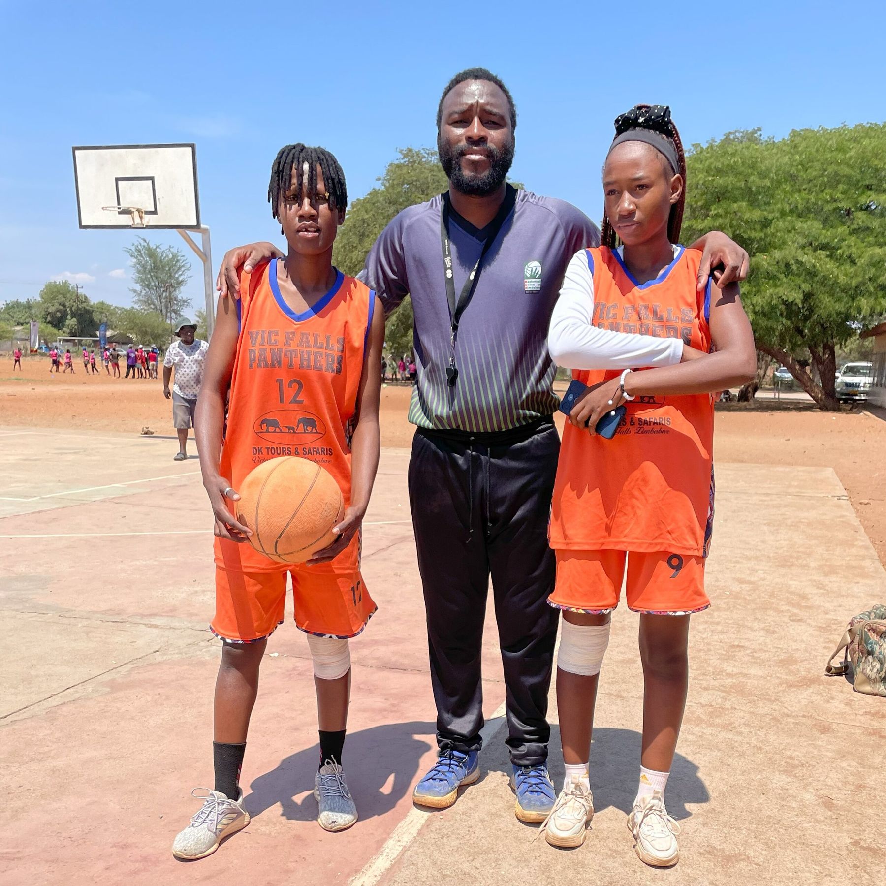 A Panthers coach with two junior players