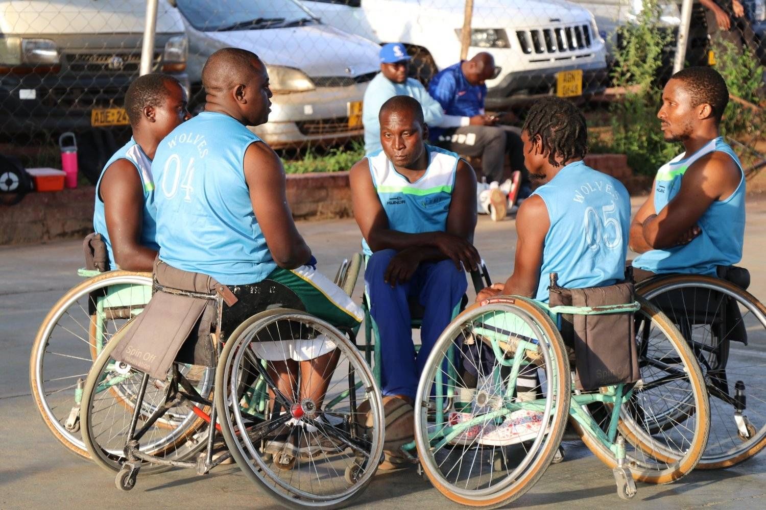 Wheelchair basketball players courtside between games